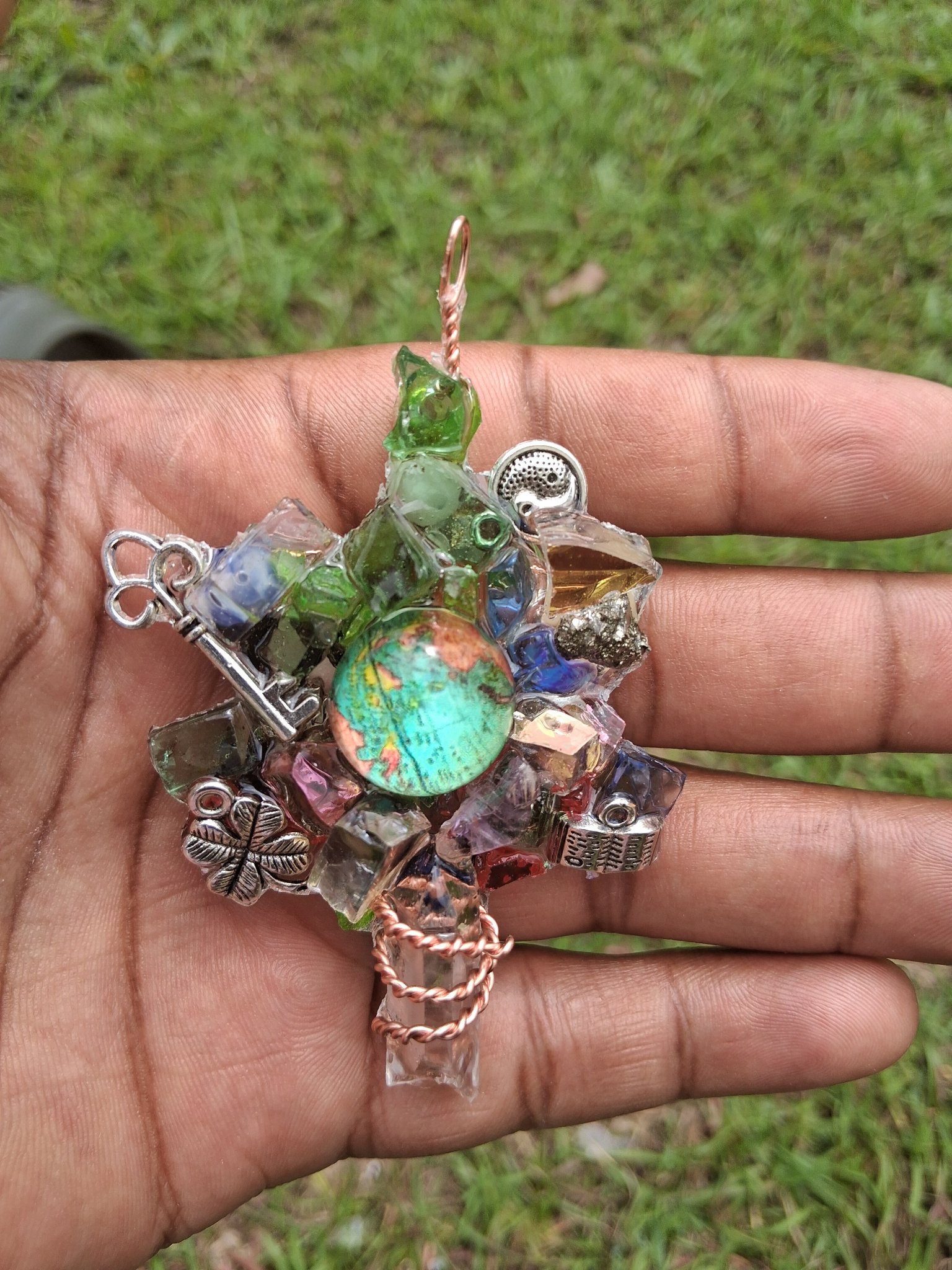 Copper neck piece with green, blue, and violet crystal details