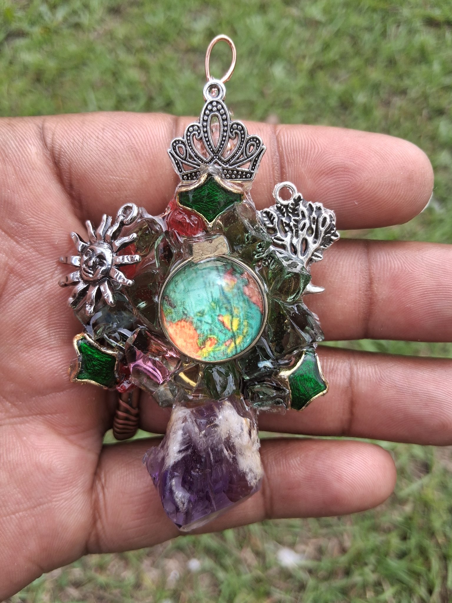 Copper neck piece with a luminous green centerpiece and amethyst point